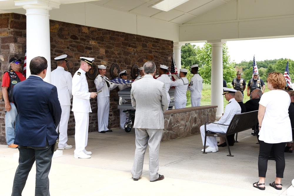 A military funeral is held for F1C Angelo Gabriele.