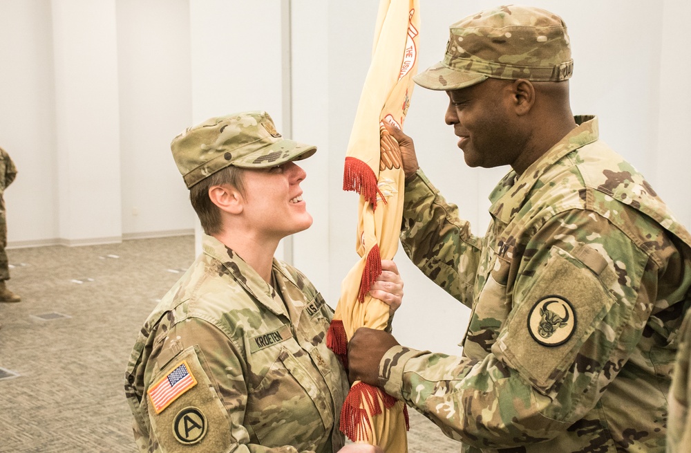 Maj. Christl Kroeten, the 275th Combat Sustainment Support Battalion (CSSB), Outgoing Battalion Commander,  gives the unit’s flag to the 518th Brigade Commander, Col. Gerry Jackson.