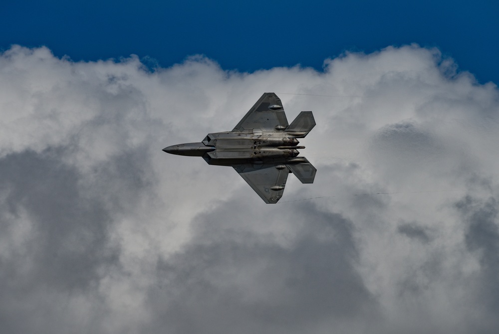 Across the silver lining: F-22 performs airshow maneuver demonstration