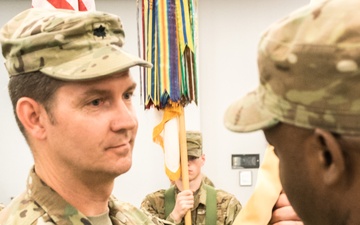 Incoming Battalion Commander, Lt. Col. Seth C. Pedersen, receives the unit’s flag from the 518th Brigade Commander, Col. Gerry Jackson,