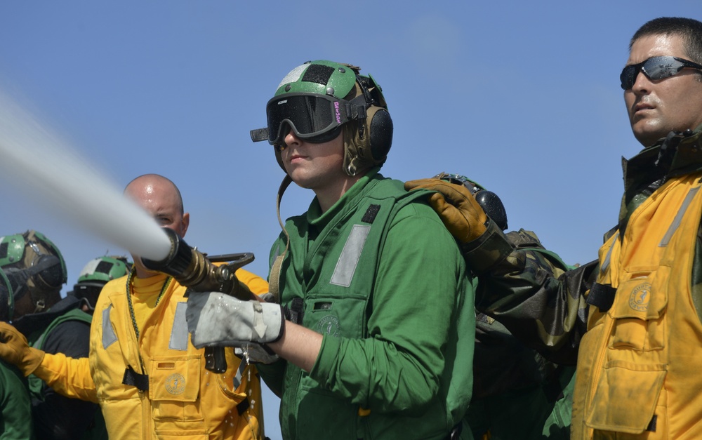 Nimitz Sailors Spray Agent During Flight Deck Drills