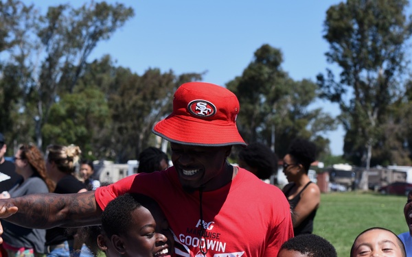 Travis youth play football with 49ers Pro athlete