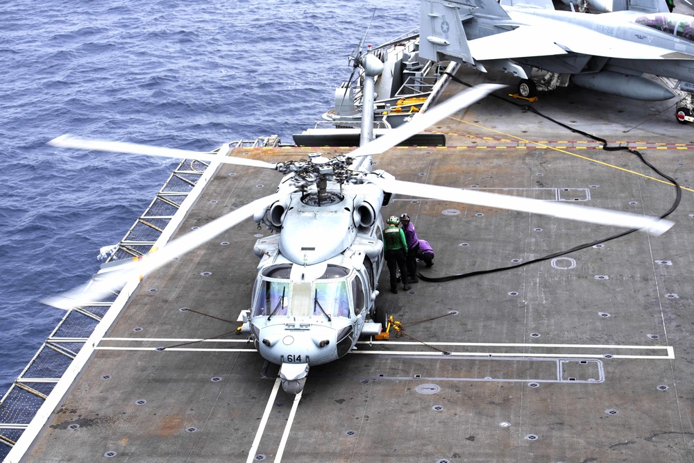 Nimitz Sailors Fuel an MH-60S Sea Hawk