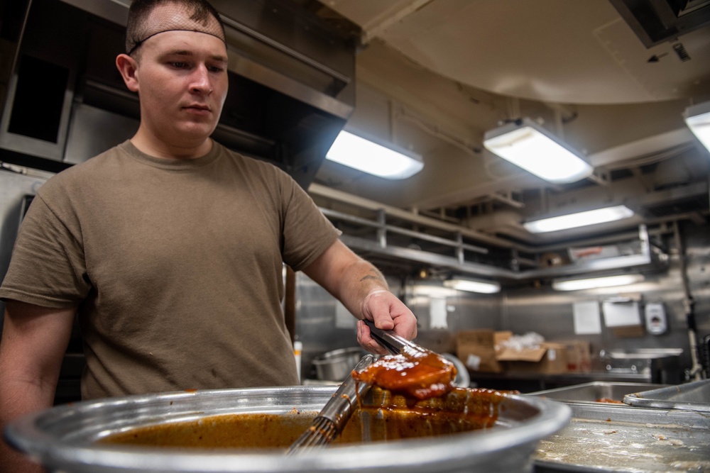 Sailor Cooks Aboard USS Harpers Ferry