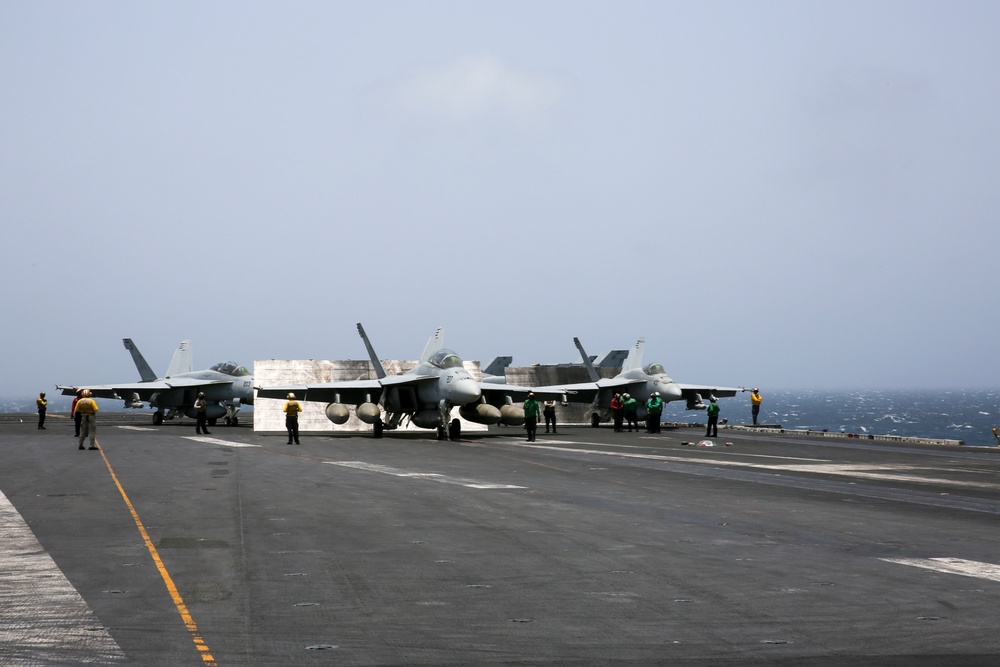 F/A-18 Super Hornets wait to be launched from the flight deck of the Nimitz-class aircraft carrier USS Abraham Lincoln (CVN  72)