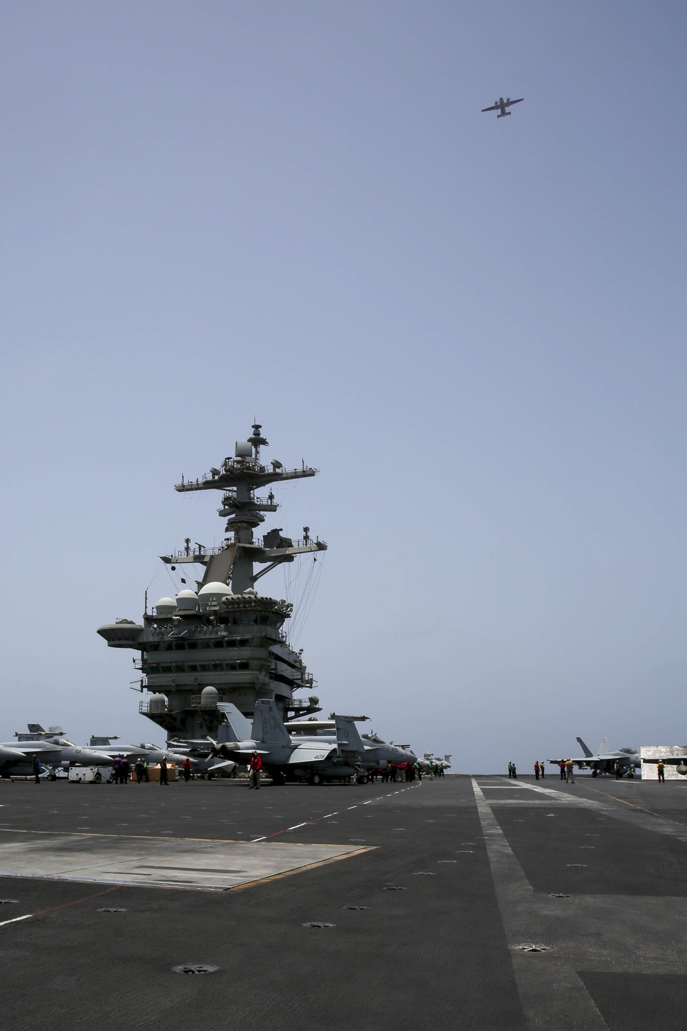 A C-2A Greyhound flies over the Nimitz-class aircraft carrier USS Abraham Lincoln (CVN 72).
