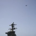 A C-2A Greyhound flies over the Nimitz-class aircraft carrier USS Abraham Lincoln (CVN 72).