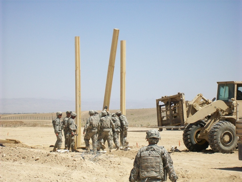 Army personnel building an observation platform in the Middle East