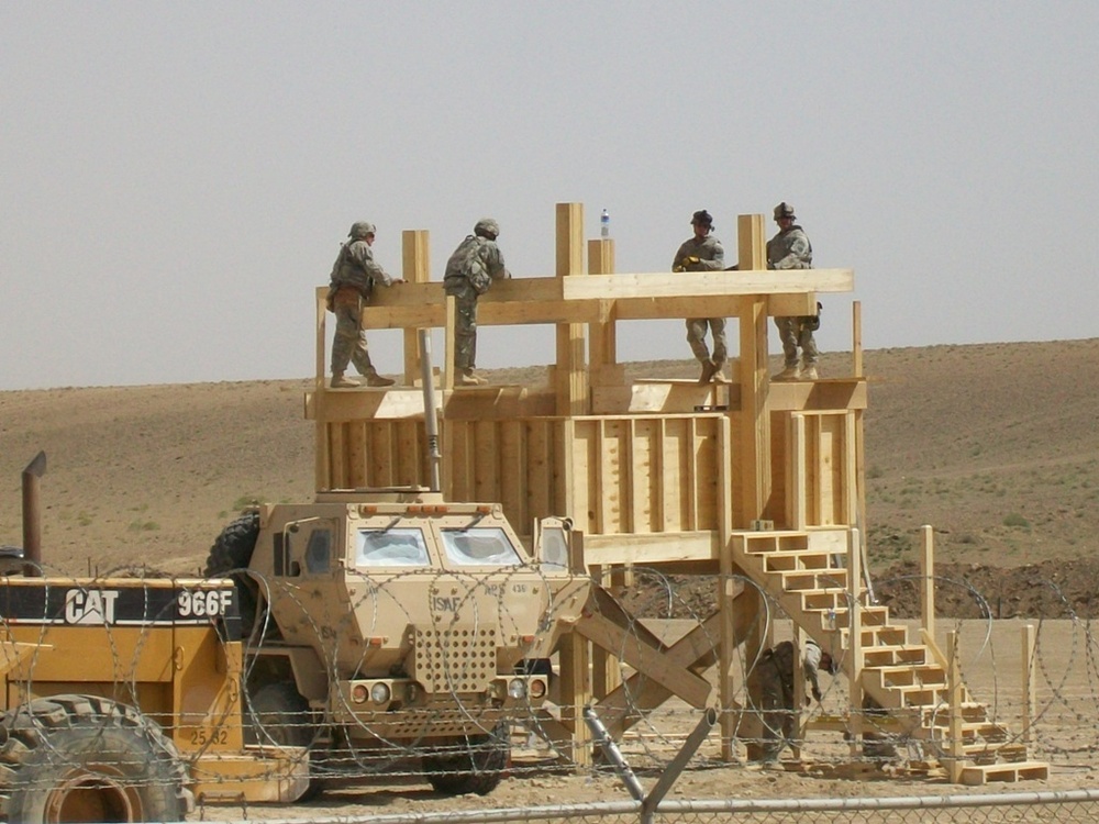 Army personnel build observation platform in the Middle East