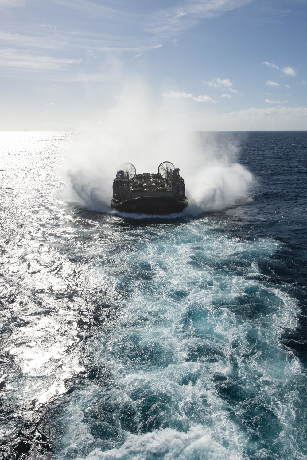 USS Wasp (LHD 1) and (NBU) 7 conduct Landing Craft, Air Cushion (LCAC) operations at sea