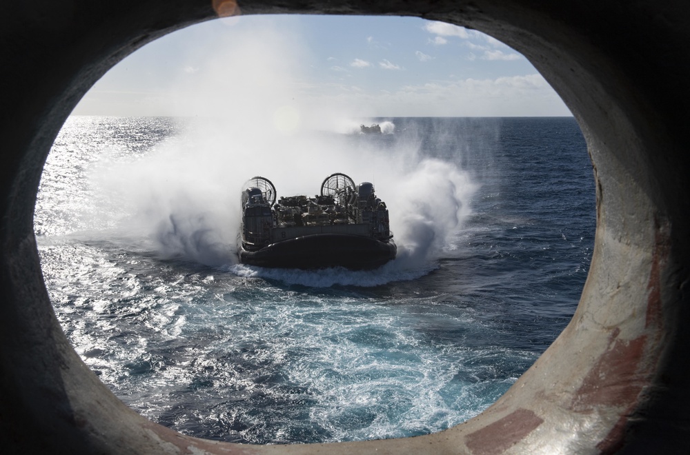 USS Wasp (LHD 1) and (NBU) 7 conduct Landing Craft, Air Cushion (LCAC) operations at sea