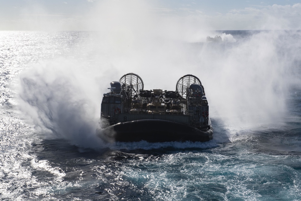 USS Wasp (LHD 1) and (NBU) 7 conduct Landing Craft, Air Cushion (LCAC) operations at sea