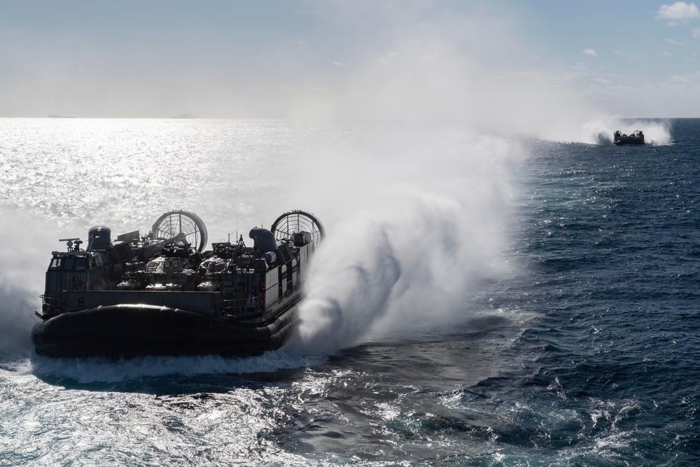 USS Wasp (LHD 1) and (NBU) 7 conduct Landing Craft, Air Cushion (LCAC) operations at sea