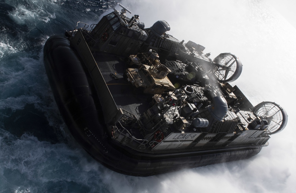 USS Wasp (LHD 1) and (NBU) 7 conduct Landing Craft, Air Cushion (LCAC) operations at sea