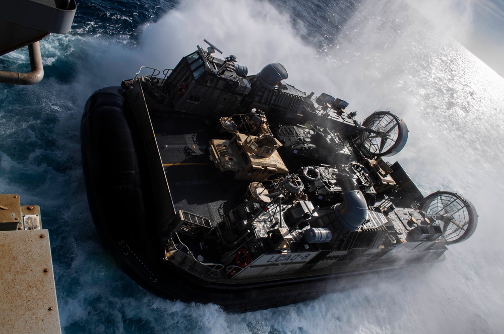 USS Wasp (LHD 1) and (NBU) 7 conduct Landing Craft, Air Cushion (LCAC) operations at sea