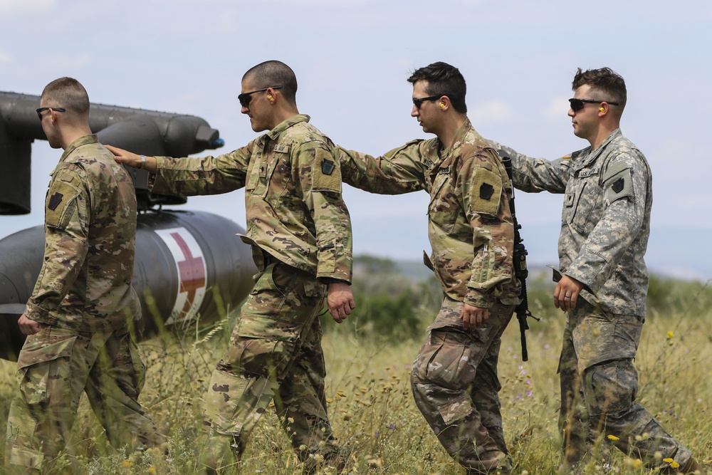 Medics of the headquarters company practice cold and hot load training aboard Blackhawk