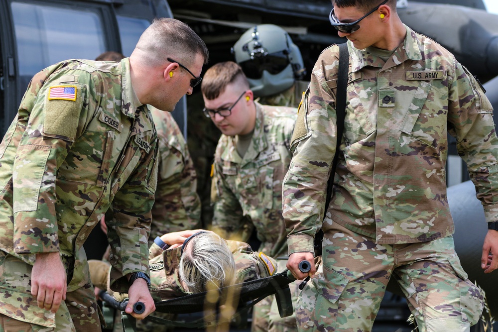 Medics of the headquarters company practice cold and hot load training aboard Blackhawk