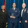 Airman Leadership School Leadership Award Three individuals pose for a formal photograph at what appears to be a military awards ceremony. The central figure, wearing a U.S. Air Force dress uniform, holds a crystal/glass award trophy. They are flanked by a woman in civilian business attire and a senior non-commissioned officer in a formal Air Force mess dress uniform with multiple medals.