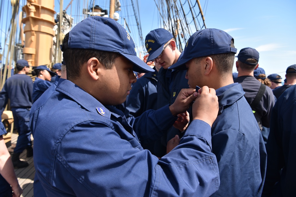 Coast Guard Cadets aboard the U.S. Coast Guard Tall Ship Eagle switch-out their cadet shields