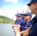 Coast Guard Cadets aboard the U.S. Coast Guard Tall Ship Eagle wave to crowds of people in France