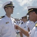 Admiral John Aquilino, Commander, U.S. Pacific Fleet, awards a Sailor during an awards ceremony on USS John S. McCain