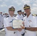 Admiral John Aquilino, Commander, Pacific FLeet, awards a Sailor during an awards ceremony on USS John S. McCain (DDG 56)