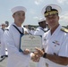 Admiral John Aquilino, Commander, Pacific FLeet, awards a Sailor during an awards ceremony on USS John S. McCain (DDG 56)