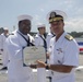 Admiral John Aquilino, Commander, Pacific FLeet, awards a Sailor during an awards ceremony on USS John S. McCain (DDG 56)