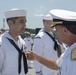 Admiral John Aquilino, Commander, Pacific FLeet, awards a Sailor during an awards ceremony on USS John S. McCain (DDG 56)
