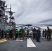 U.S. Marines and Sailors look for foreign object debris aboard the USS Bataan