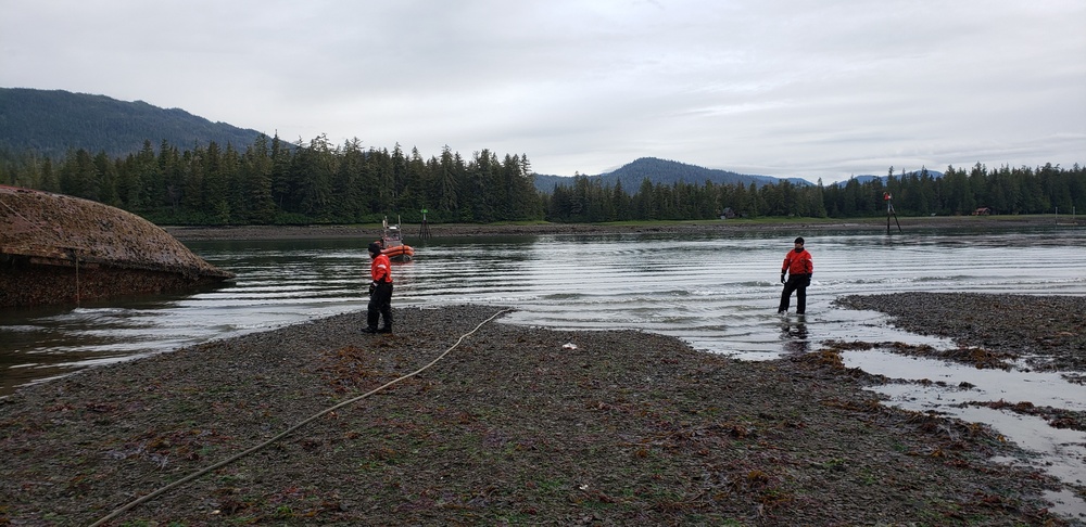 Coast Guard boat crew assesses aground, submerged recreational vessel in the Wrangell Narrows, Alaska