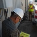 Naval Facilities Engineering Command Southwest personnel inspect damaged equipment