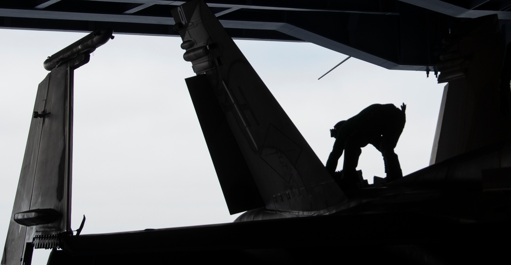 Marine Conducts Maintenance on a F/A-18C Hornet