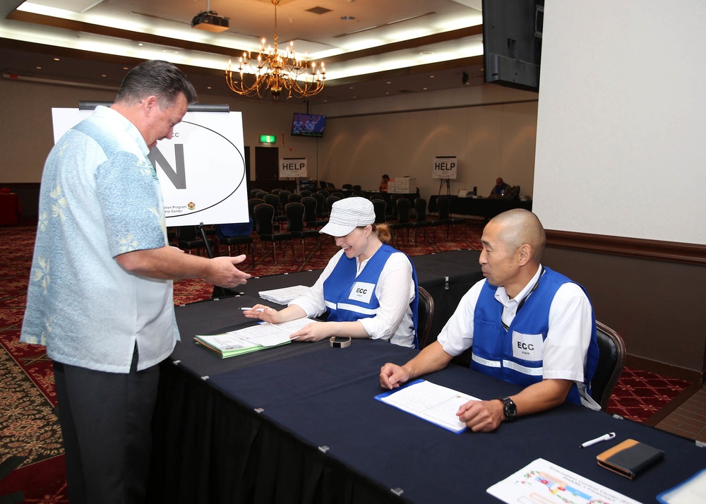 An Evacuation Control Center staff member inspects an Emergency Evacuation Program packet during an EEP muster at the Camp Zama Community Club Sept. 27, 2018.