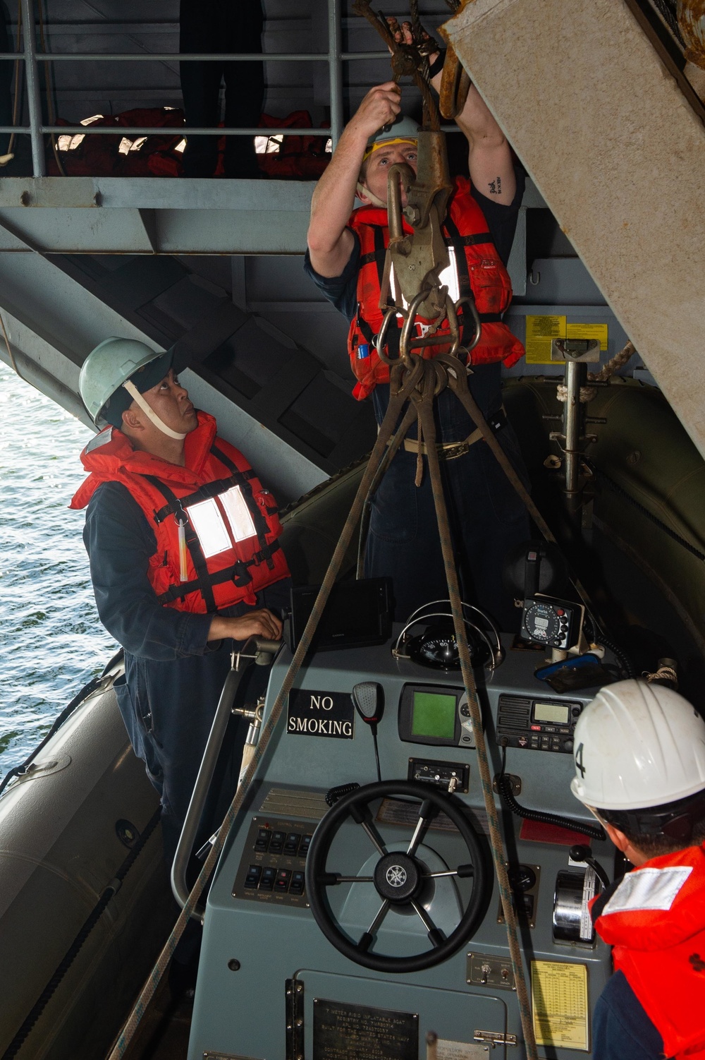 U.S. Sailors operate a rigid-hull inflatable boat