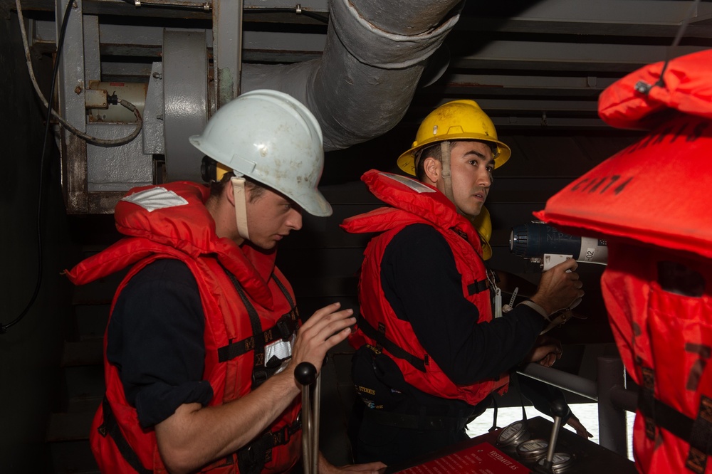 U.S. Sailors operate a rigid-hull inflatable boat