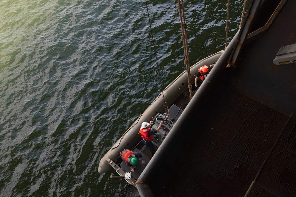 U.S. Sailors operate a rigid-hull inflatable boat