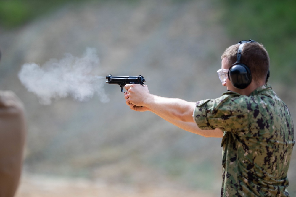 U.S. Sailors attend an M9 pistol qualification course