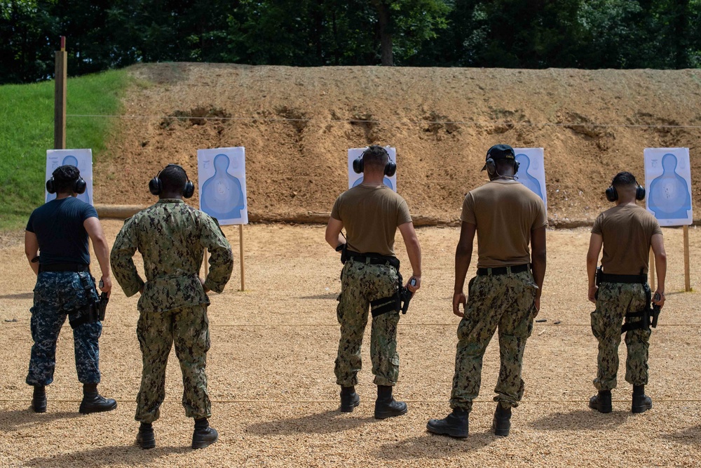 U.S. Sailors attend an M9 pistol qualification course