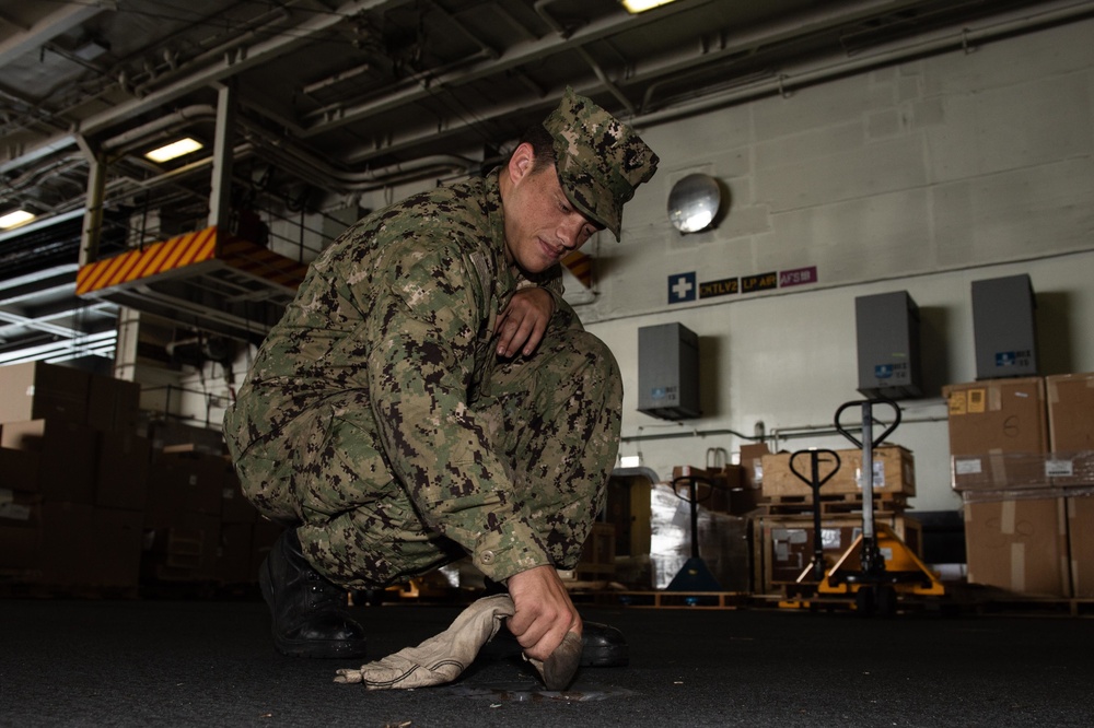 U.S. Sailor cleans a padeye