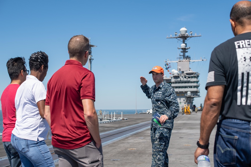 Members from Navy Recruiting Command Educator Orientation tour the aircraft carrier USS John C. Stennis (CVN 74)