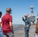 Members from Navy Recruiting Command Educator Orientation tour the aircraft carrier USS John C. Stennis (CVN 74)