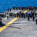 Marines and Sailors Aboard The USS Bataan look for foreign object debris