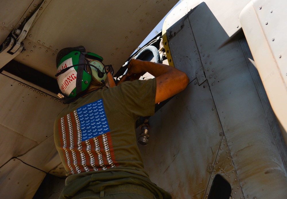 Marine Performs Maintenance On Aircraft