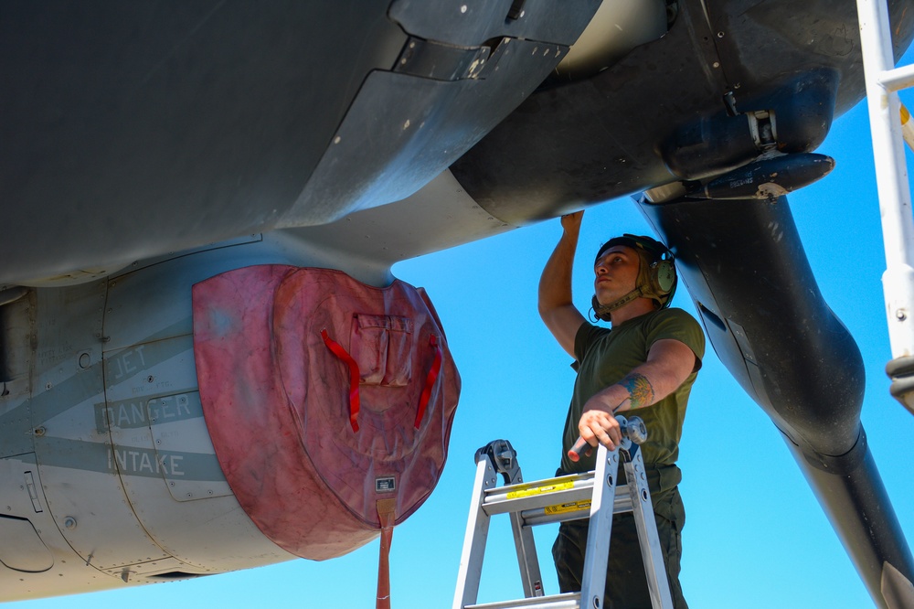 Marine Performs Maintenance On Aircraft