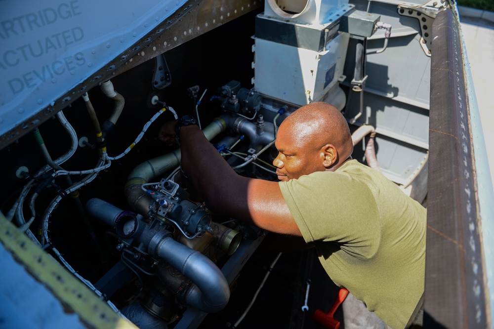 Marine Performs Maintenance On Aircraft