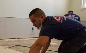 Contractors repair homes on base.