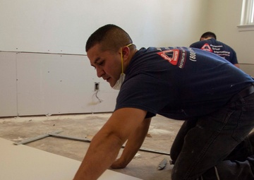 Contractors repair homes on base.
