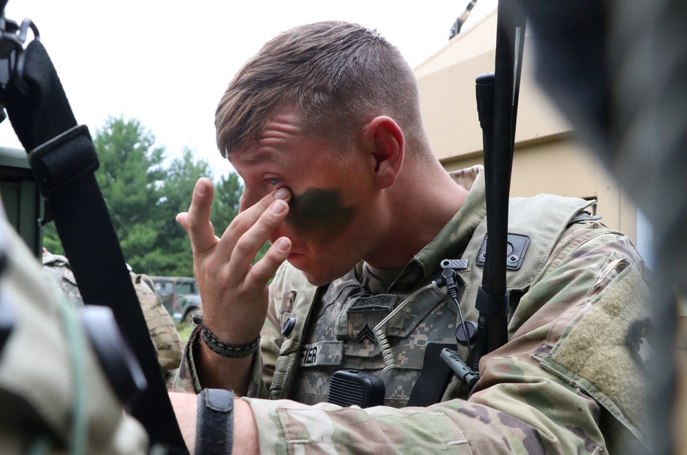 IANG Infantry Soldier Applies Face Paint at XCTC