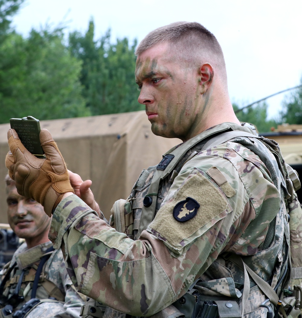 IANG Infantry Soldier Applies Face Paint at XCTC